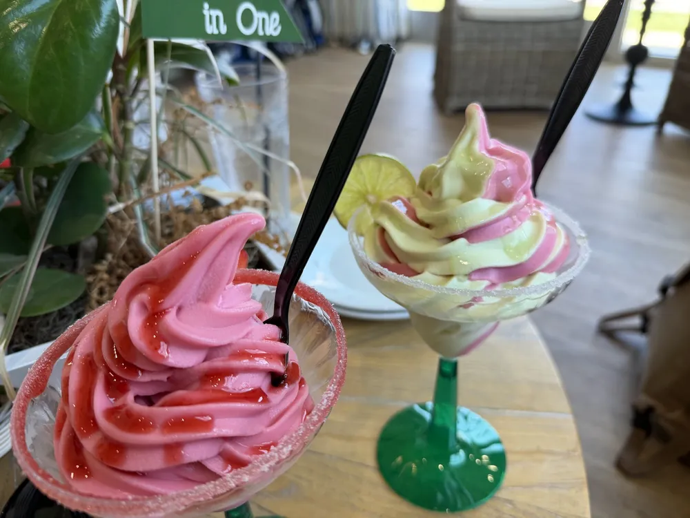 Two frozen soft-serve margaritas with sugared rims