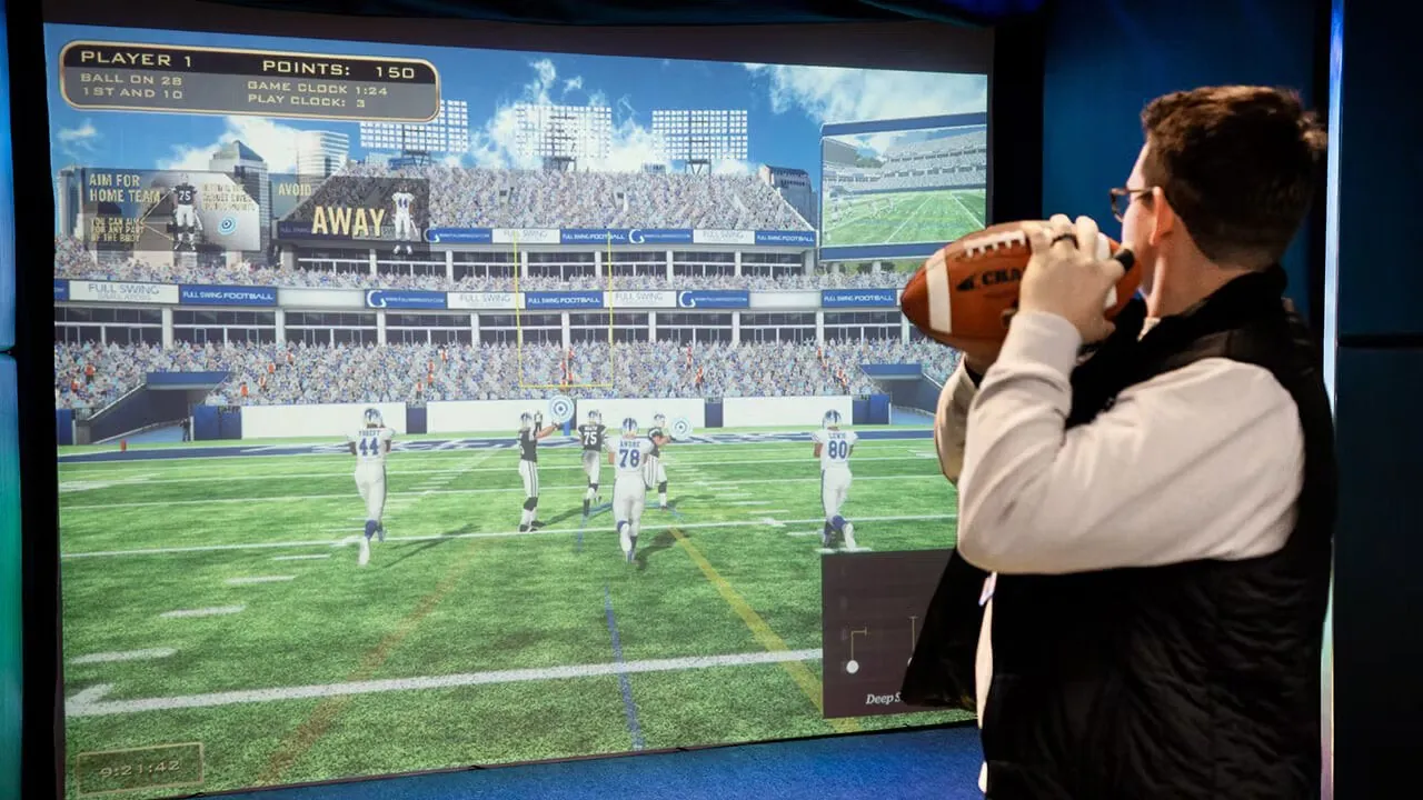 Football on the simulator screen at Tee Off at The Wharf